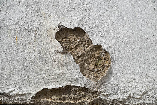 close-up of water damaged stucco wall