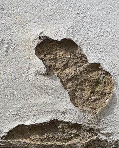 close up of water damaged stucco wall