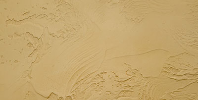 close up of textured stucco wall in beige color