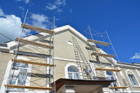 large home in Brandon with scaffolding stucco repair